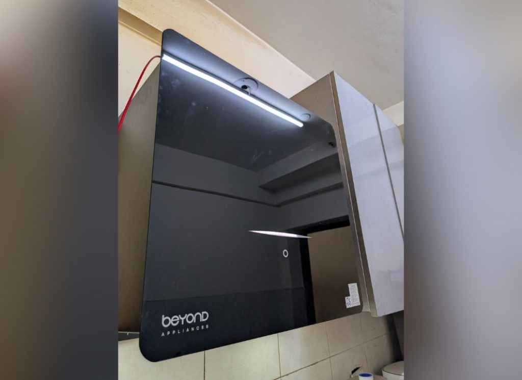 Beyondnxt Cube Chimney Review unit installed in a kitchen setup with reflective black glass panel