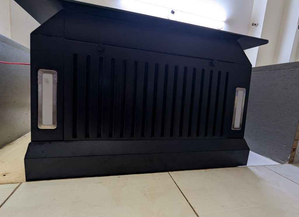 Bottom view of Beyondnxt Cube Chimney review unit showing filter grilles and oil collector trays