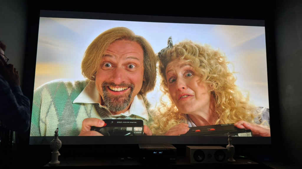 BenQ W5850 projector projecting a 155-inch wide screen from a 13-feet throw distance