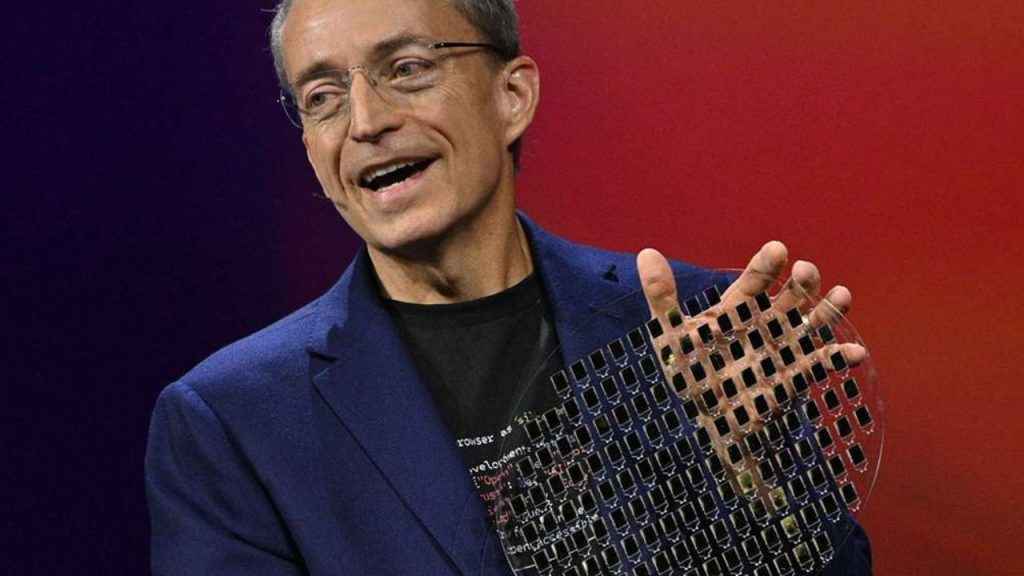 Intel CEO Pat Gelsinger holding up a glass substrate wafer with silicon photonic integrated die stack